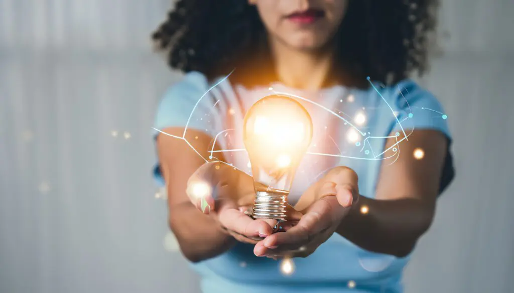 woman holding a light bulb