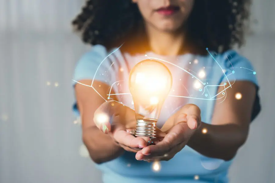 woman holding a light bulb